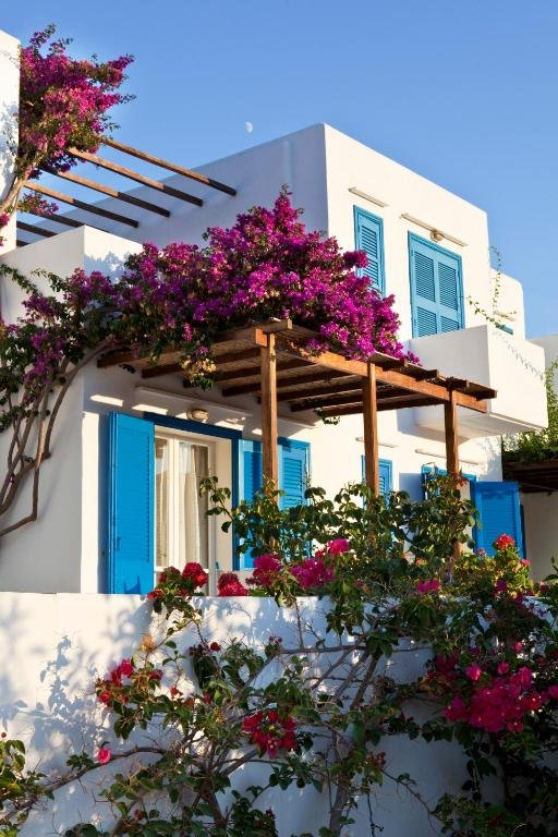 Whitewashed rooms with blue shutters and bougainvillea at Hotel Alexandros